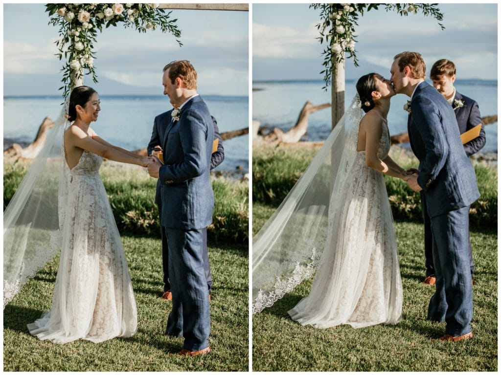 Olowalu Wedding Elopement Photographer picture of bride and groom getting married beside the ocean under ceremony arch first kiss