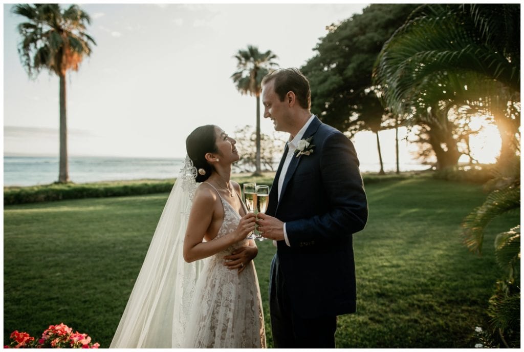 Olowalu Wedding Elopement Photographer picture of bride and groom on their wedding day with champagne in their hand