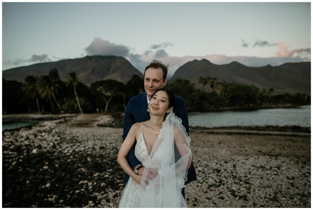 Olowalu Wedding Elopement Photographer picture of bride and groom on their wedding day watching the sunset