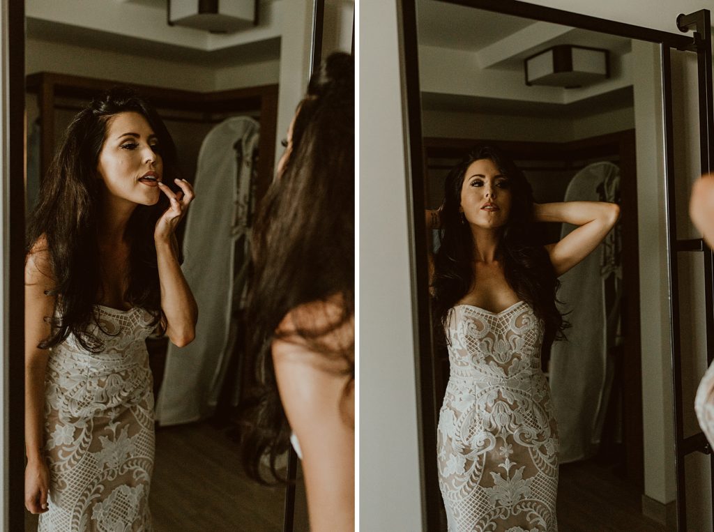 Bride looking in mirror putting on lipstick