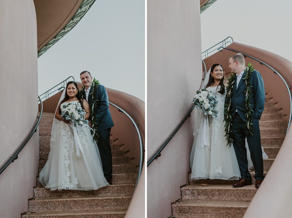Bride and Groom holding each other on curving staircase