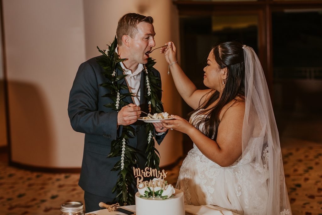 Bride feeding Groom bite of cake during Reception