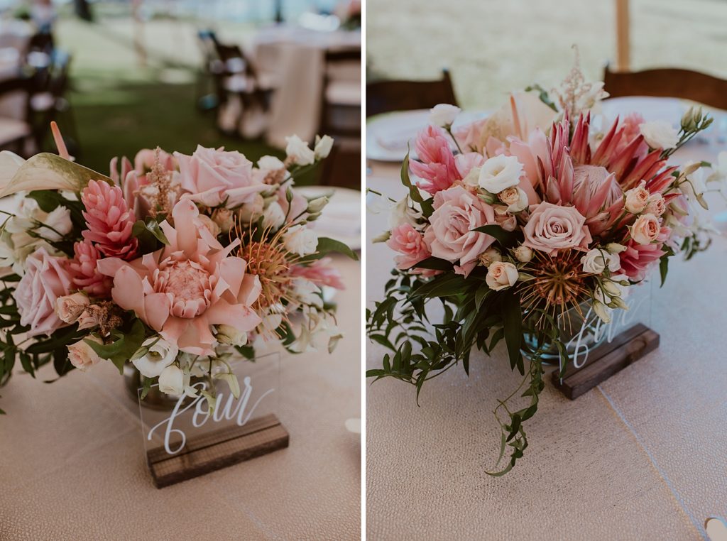 Detail shot of tropical pink flower centerpieces with table numbers