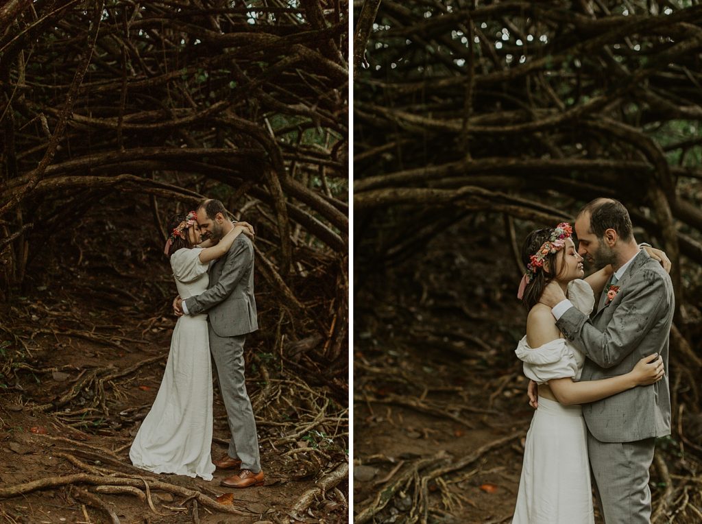 Bride and Groom holding each other close in branch forest
