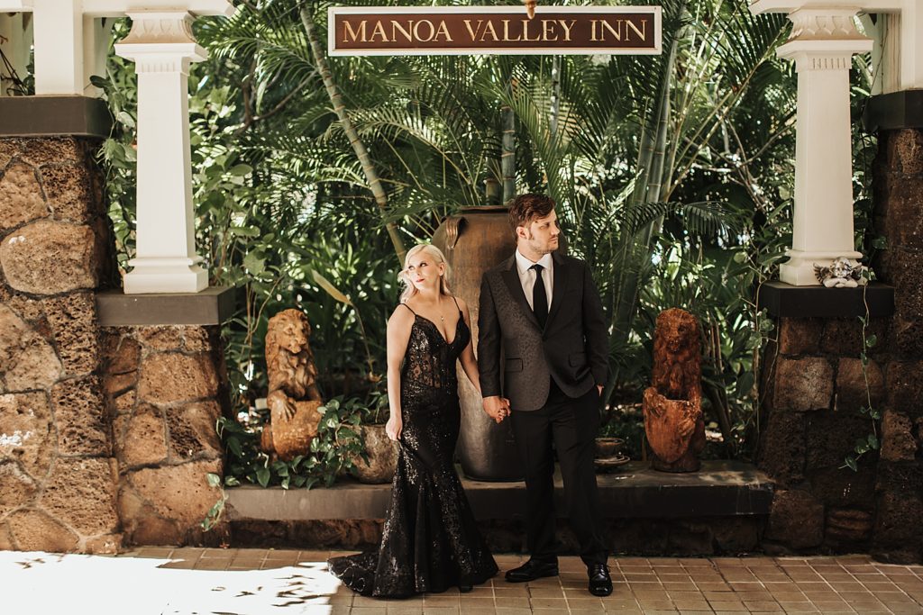 Bride and Groom holding hands underneath Manoa Valley Inn sign