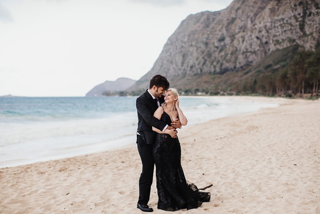 Groom holding Bride on the sand on the beach