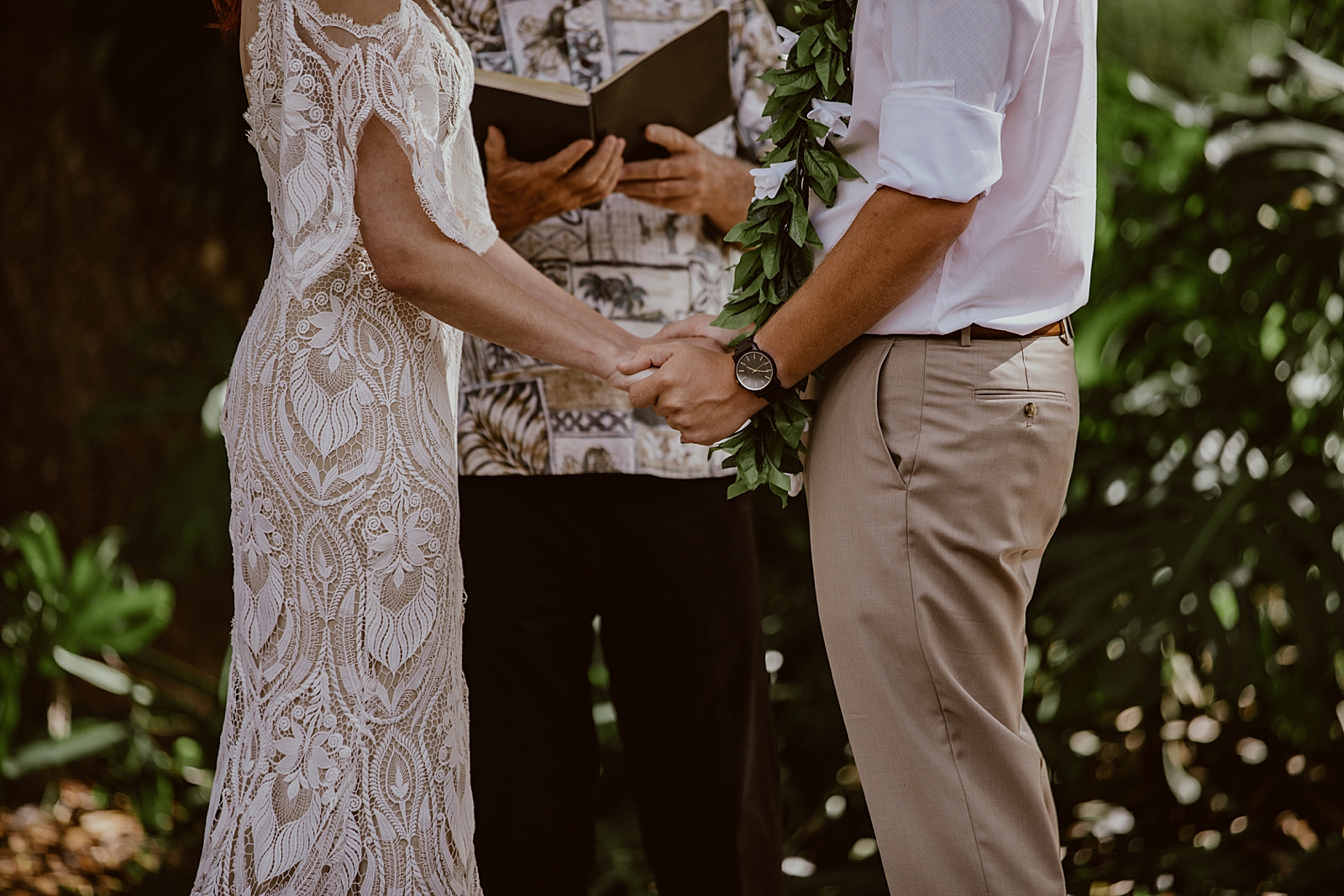 Closeup of Bride and Groom holding hands during outdoor Ceremony
