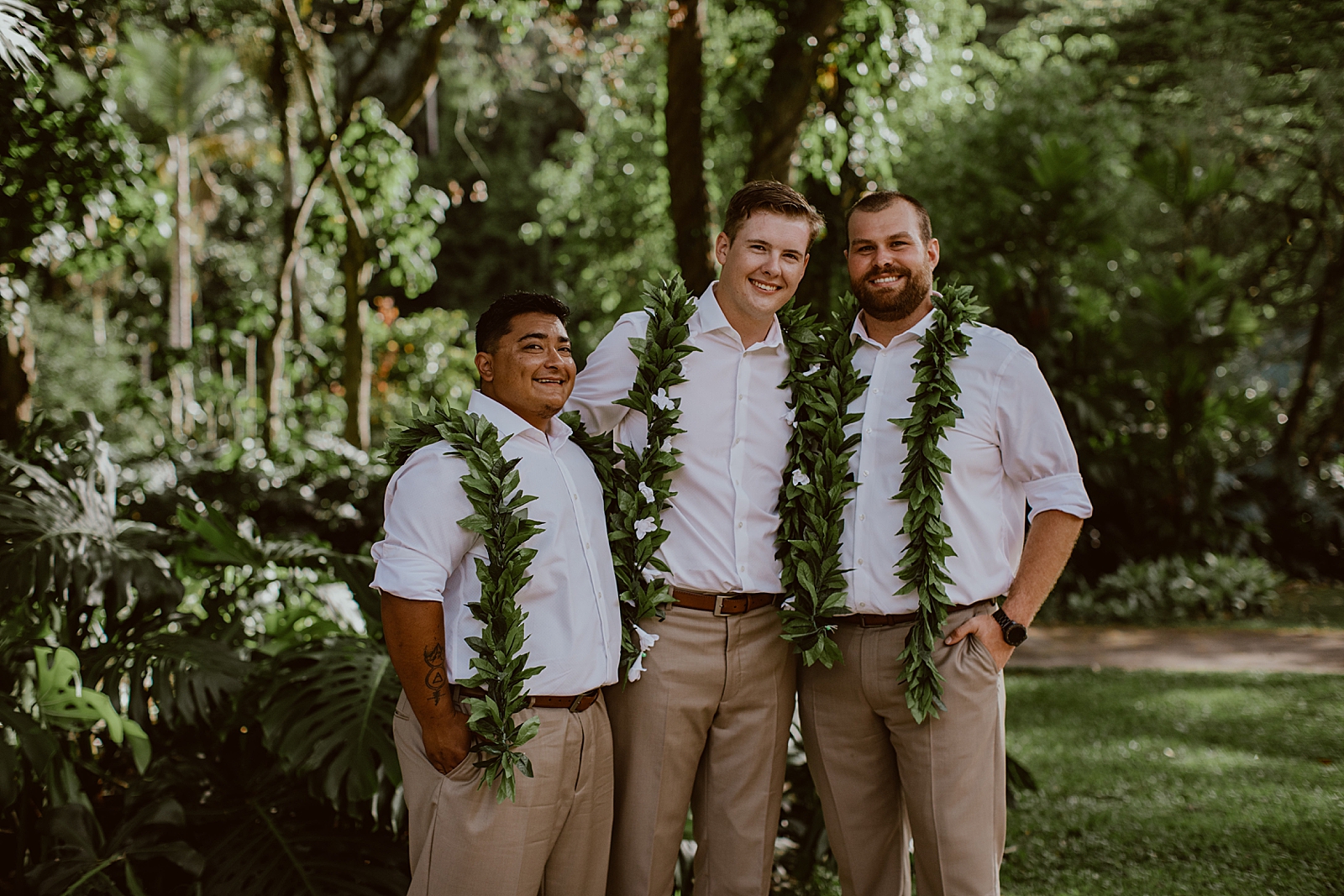 Groom with groomsmen outside in tropical green forest