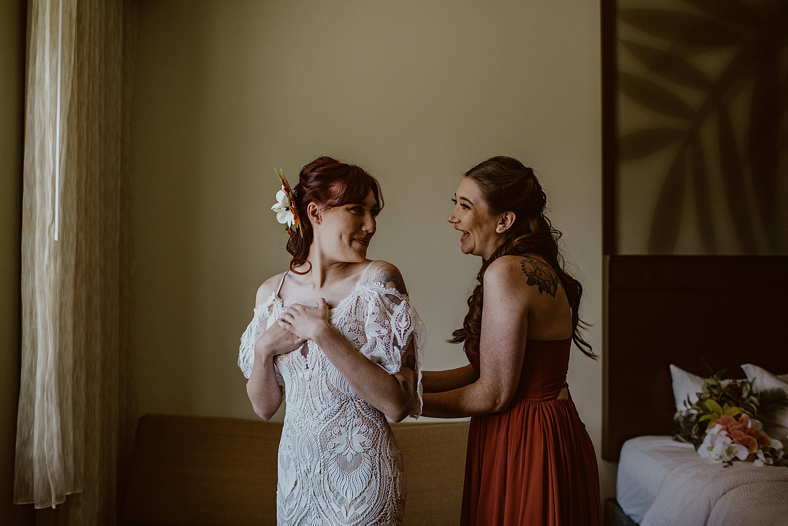 Bride and Maid of Honor laughing as they get ready