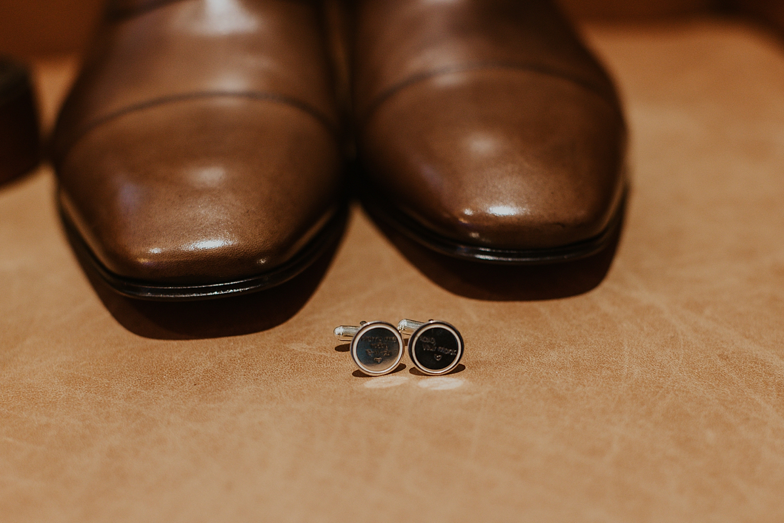 Detail shot oif cuff locks and Groom's shoes