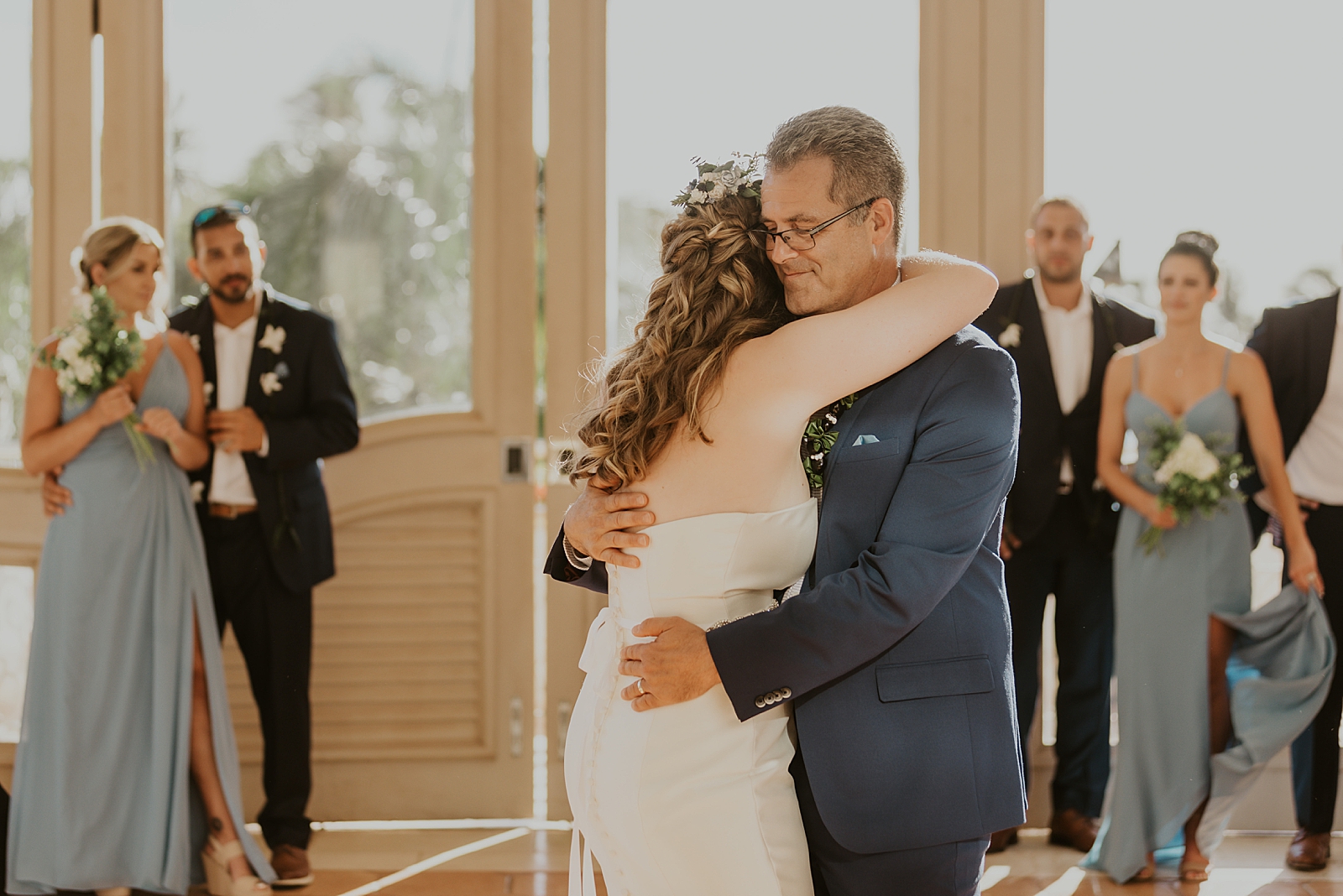 Bride hugging Father during father daughter dance