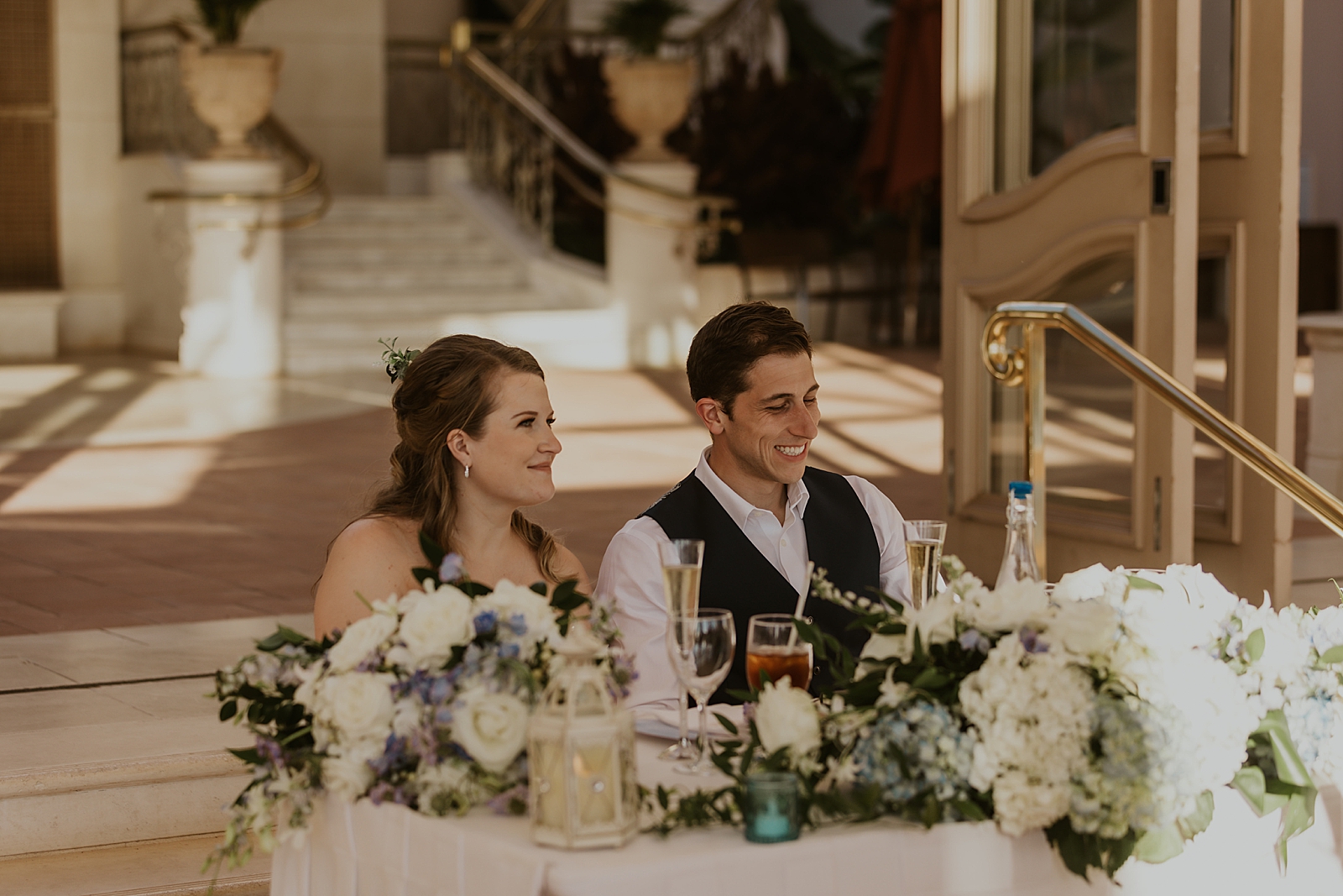 Bride and Groom sitting at sweetheart table together during speeches