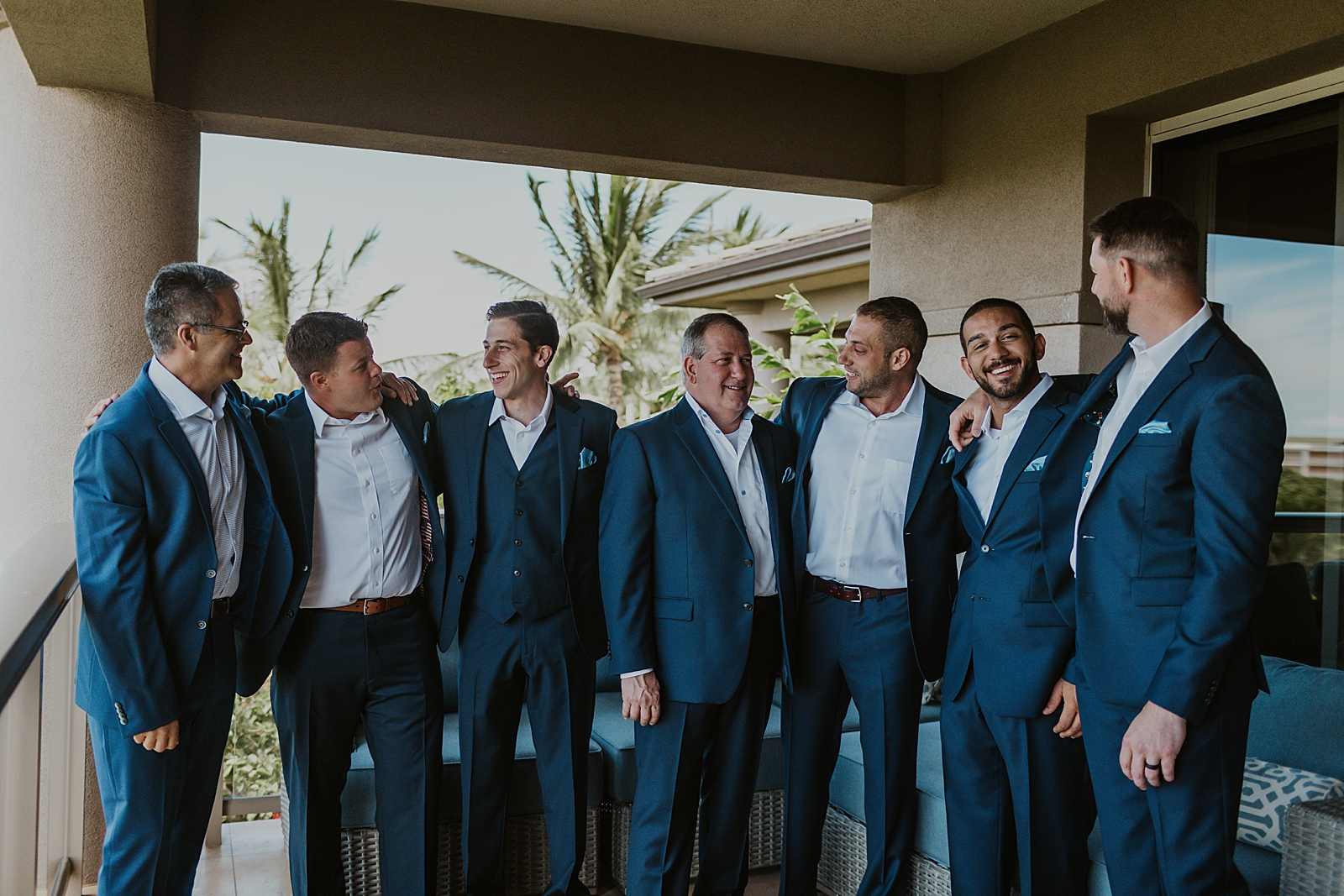 Groom with groomsmen after getting ready arms around each other