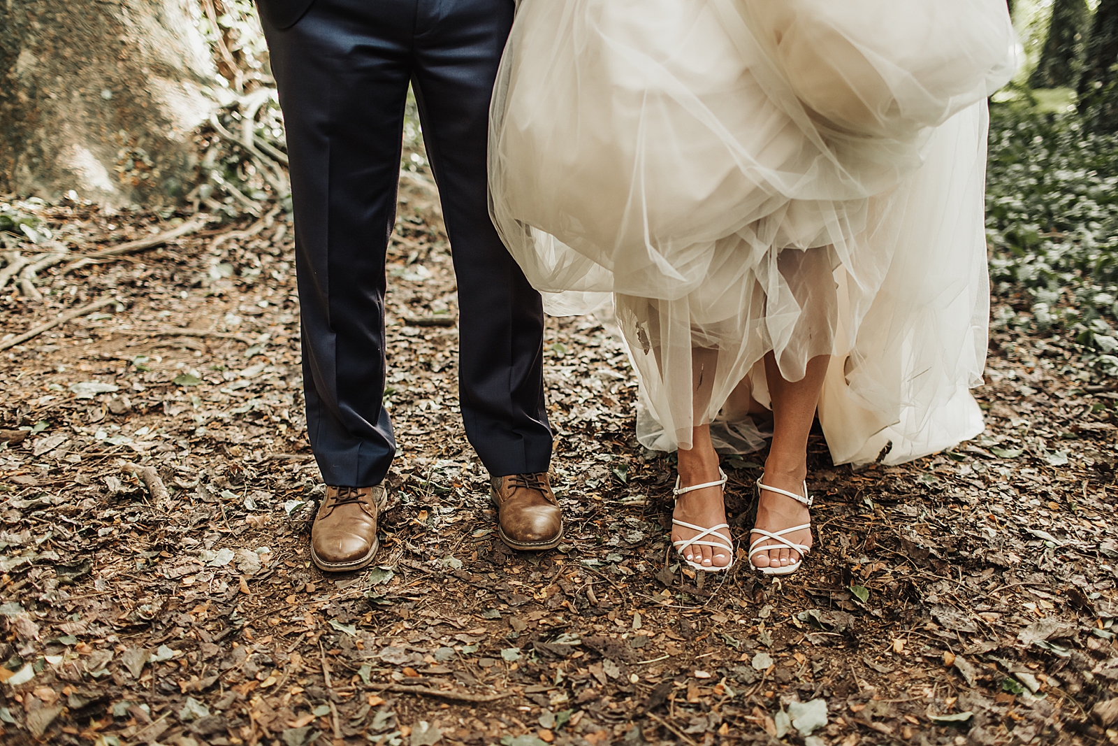 Closeup of Bride and Groom;s feet on the ground of the forest