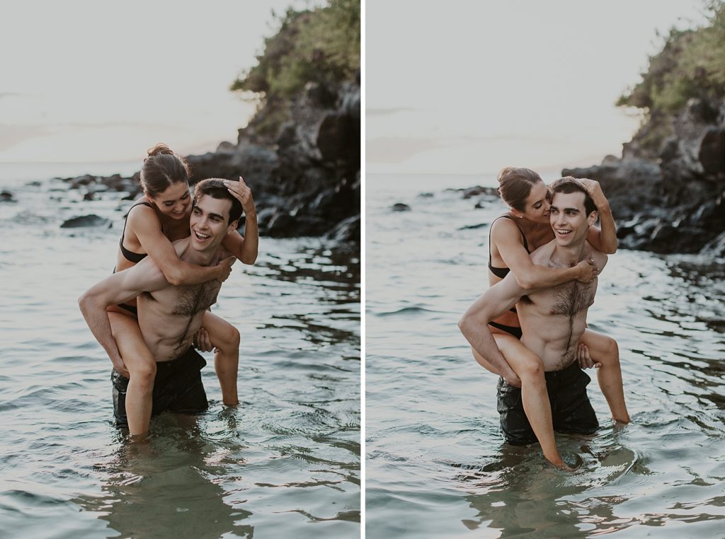 Woman piggy back riding on man's back while knee deep in water