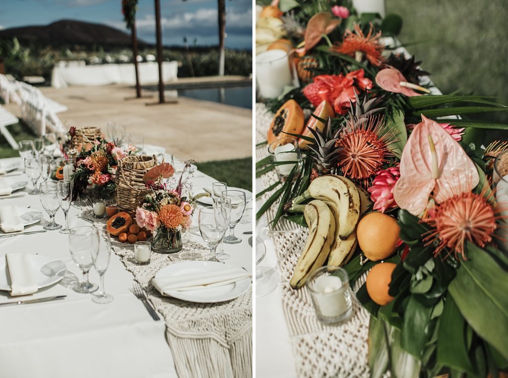 Detail shot of rectangular table with white table cloth with tropical fruit and flowers 