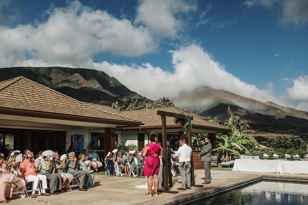 Shot of guests sitting for Ceremony with mountains in the background with clouds touching the tops