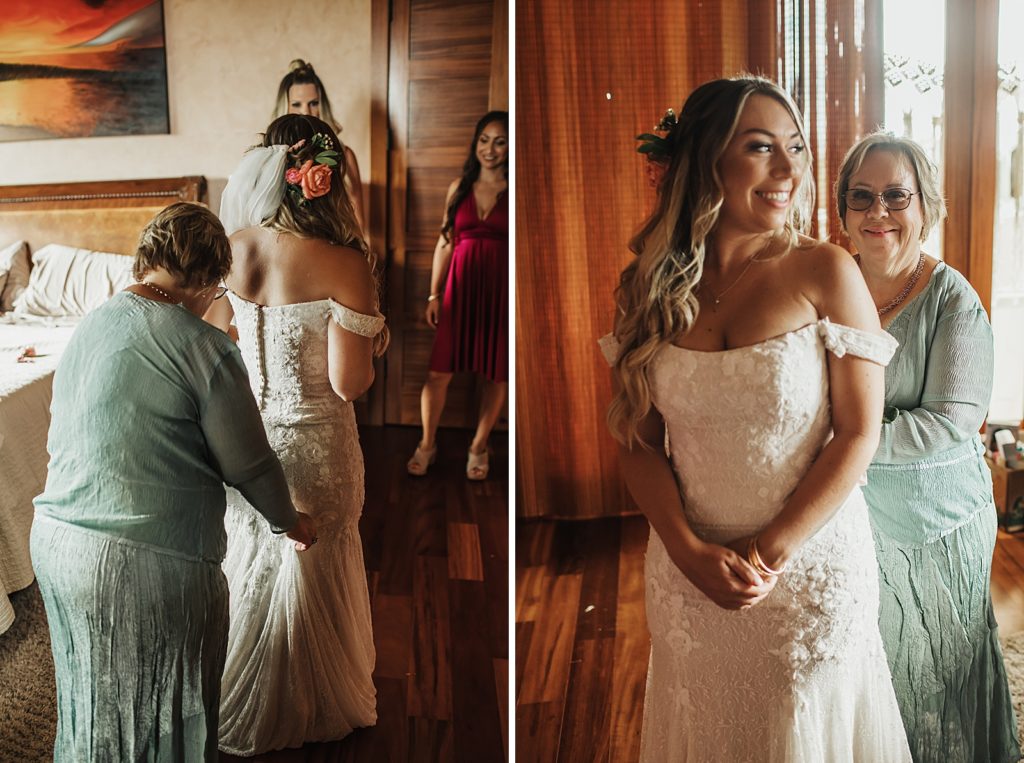 Bride with her dress on after mother helping put on dress