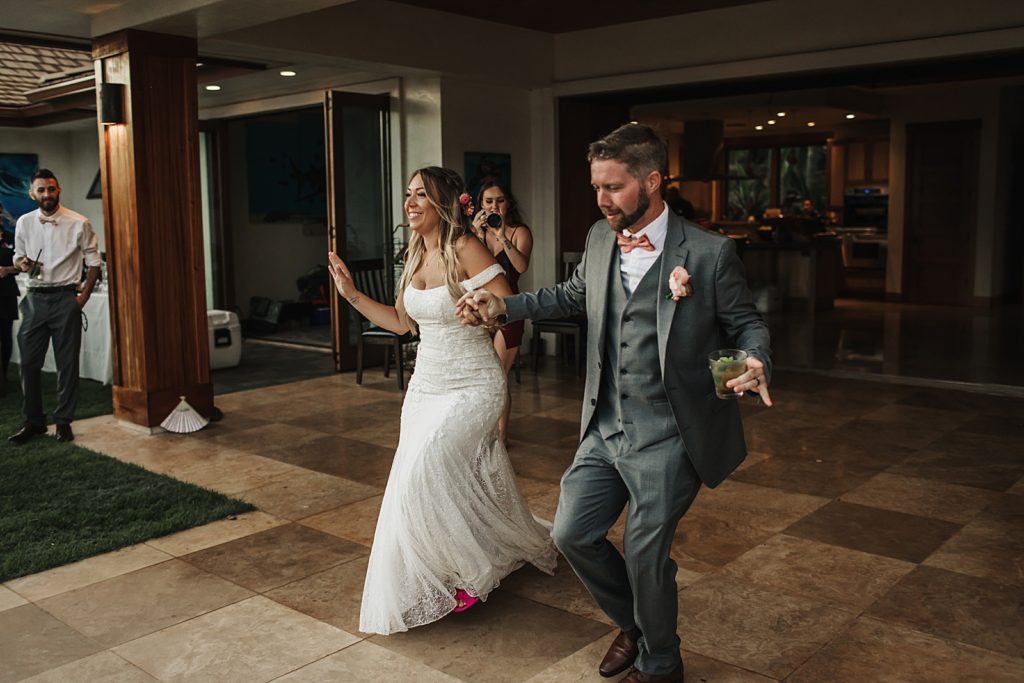 Bride and Groom holding hands and entering Reception together