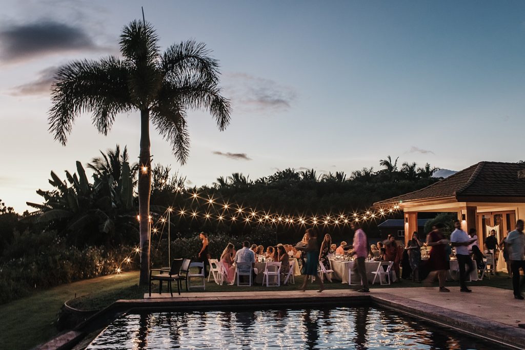Wide shot of outdoor Reception with lights hanging at night