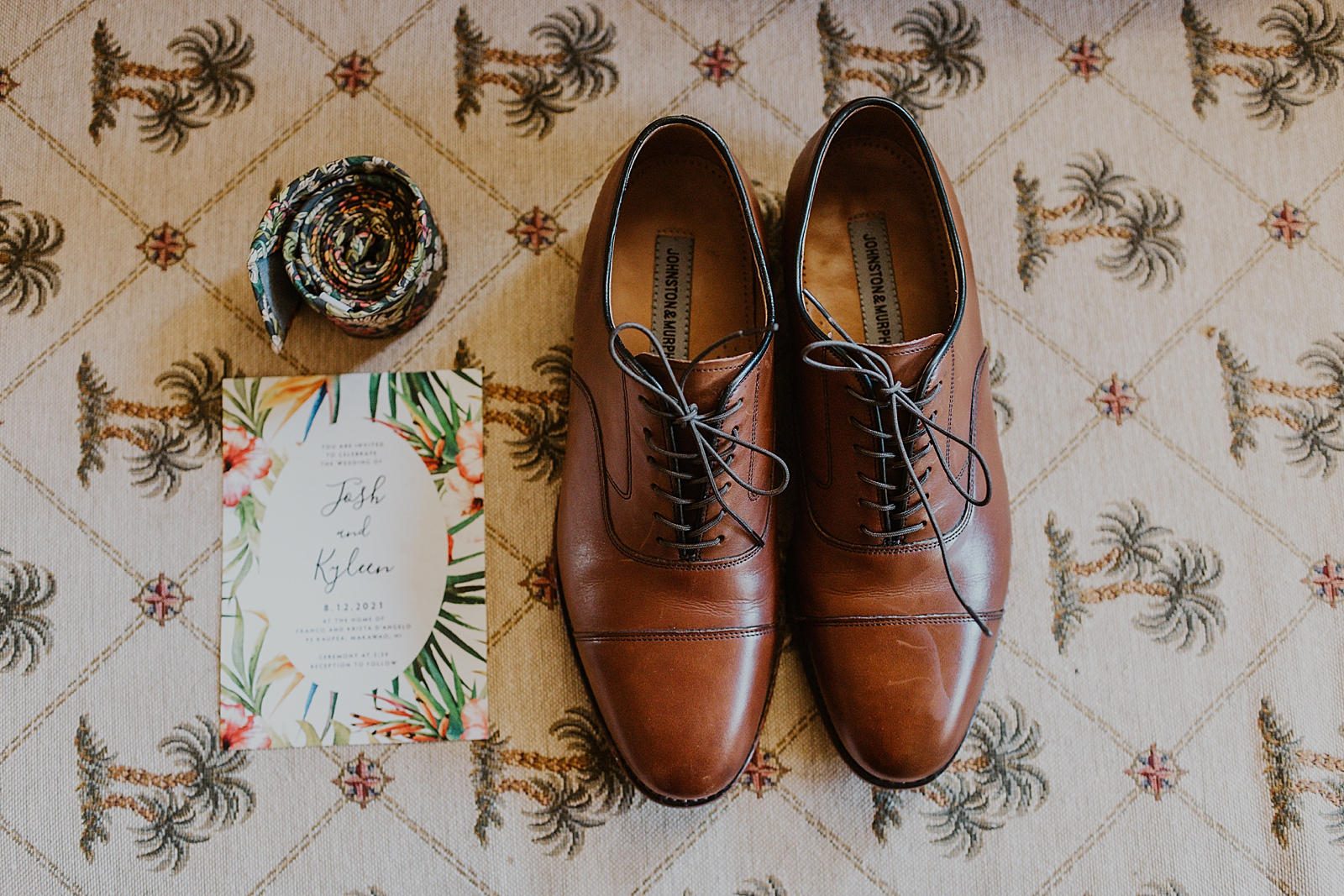 Detail shot of Groom's shoes tie and invitation