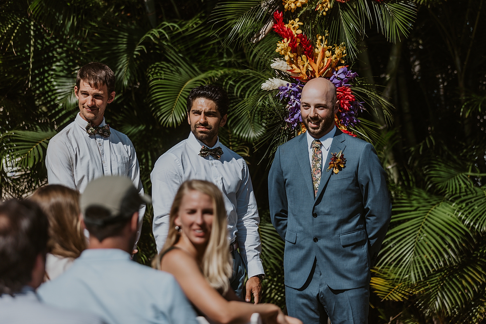 Groom awaiting Bride at the alter with Groomsmen by tropical leafs for outdoor Ceremony