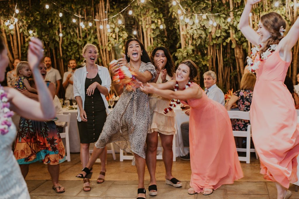 Single ladies struggling to catch bouquet at Reception