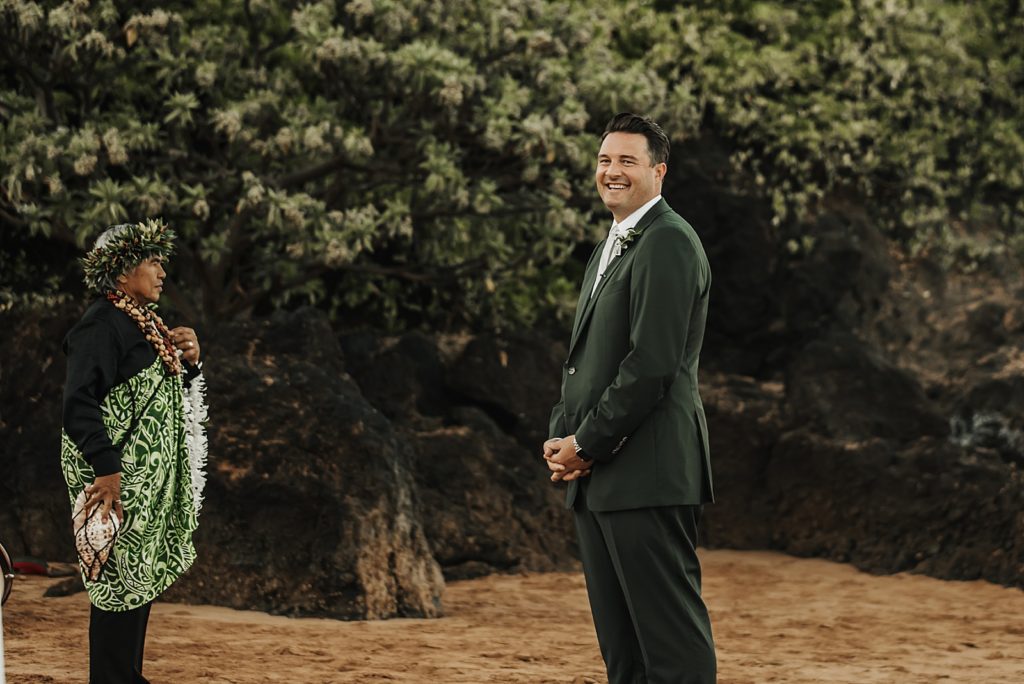 Groom awaiting Bride on the beach by the trees