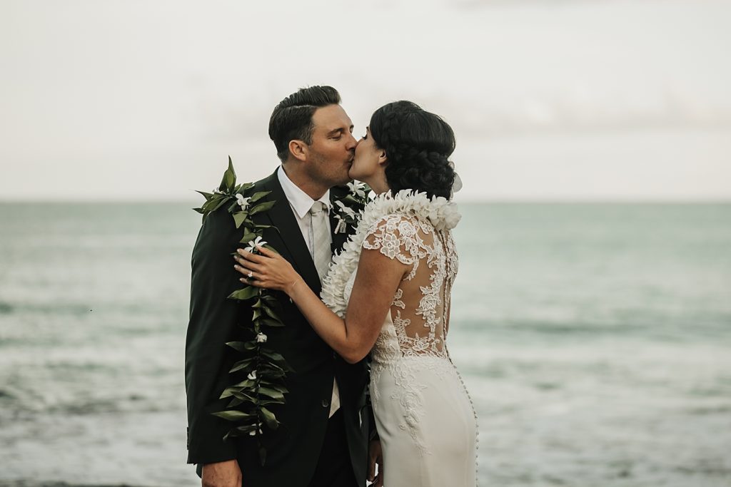 Bride and Groom kissing in front of the ocean