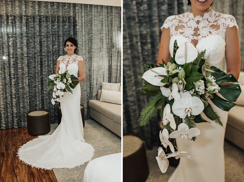 Bride in wedding dress holding white tropical bouquet