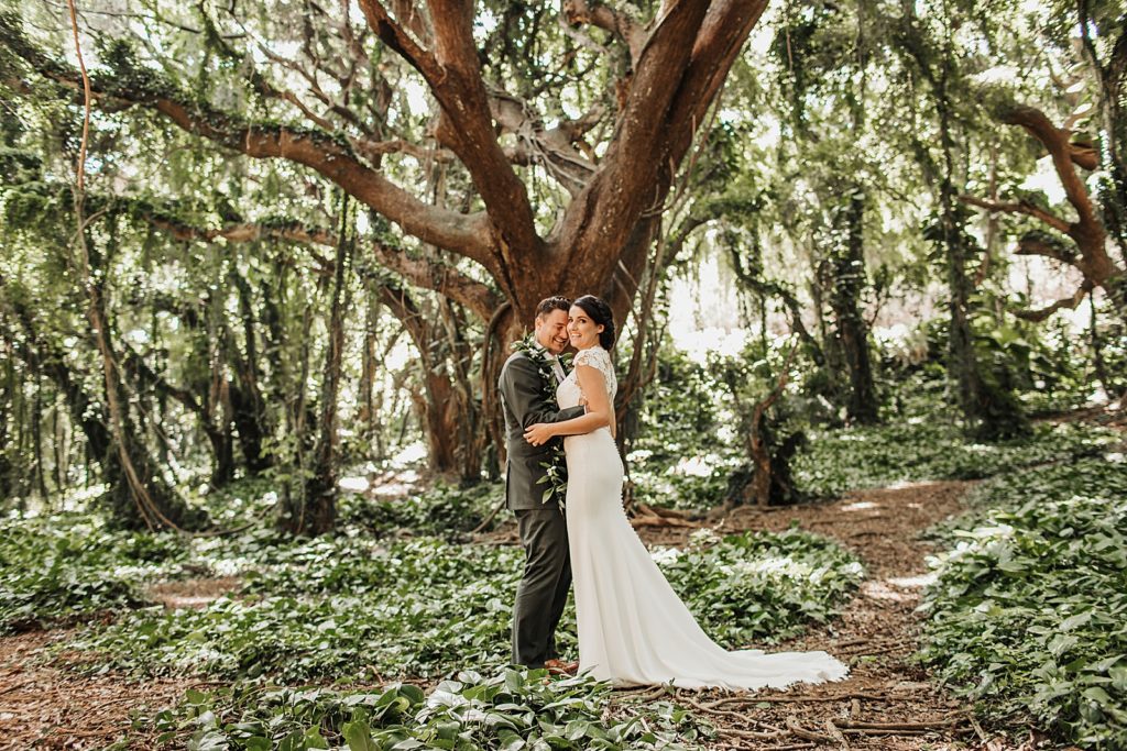 Bride and Groom hugging in the forest 