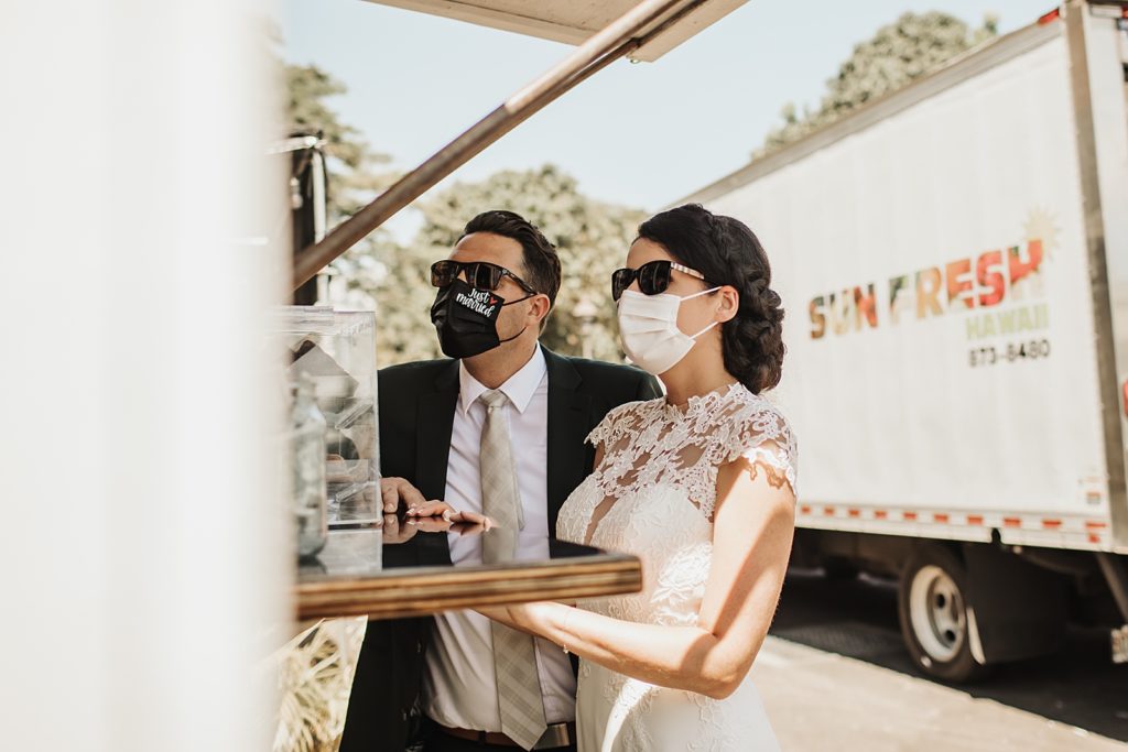 Bride and Groom with masks on ordering at food truck