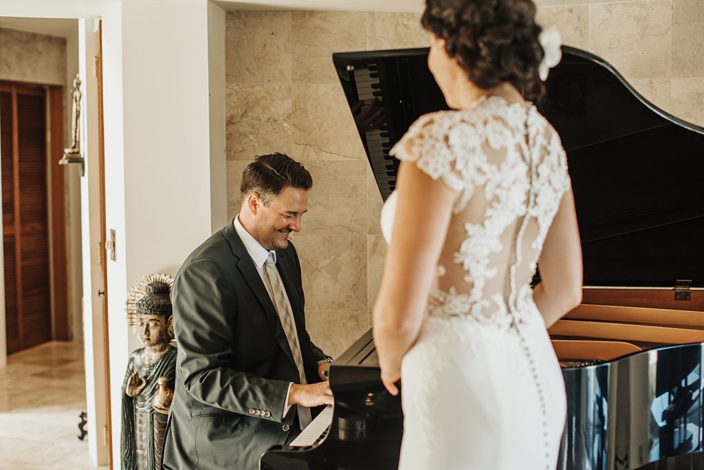 Groom playing grand piano with Bride listening