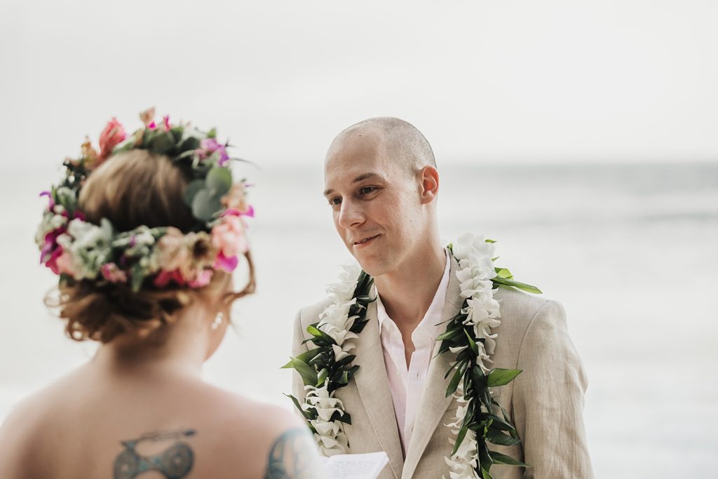 Closeup of Groom looking Bride in the face by the ocean