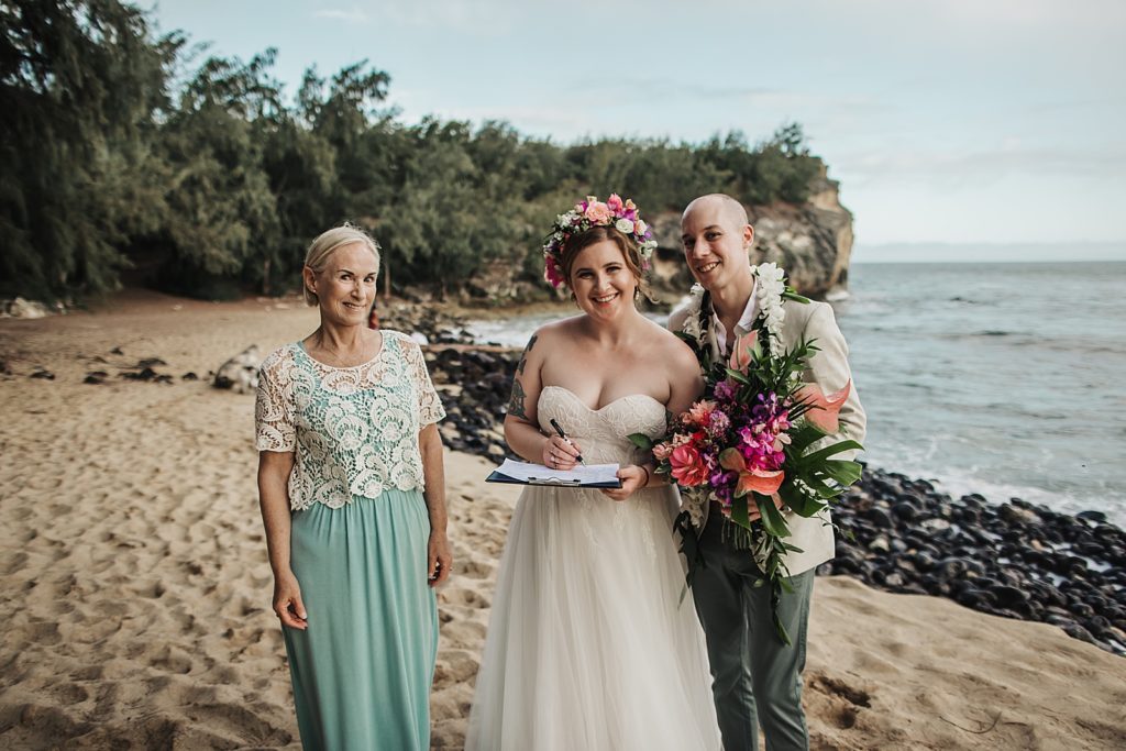 Bride and Groom portrait with officiant on the beach