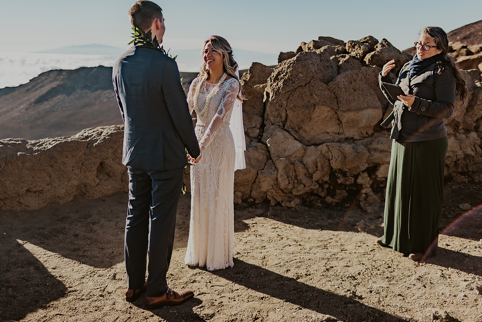 Bride and Groom looking and holding hands at each other for Mountain Elopement Ceremony