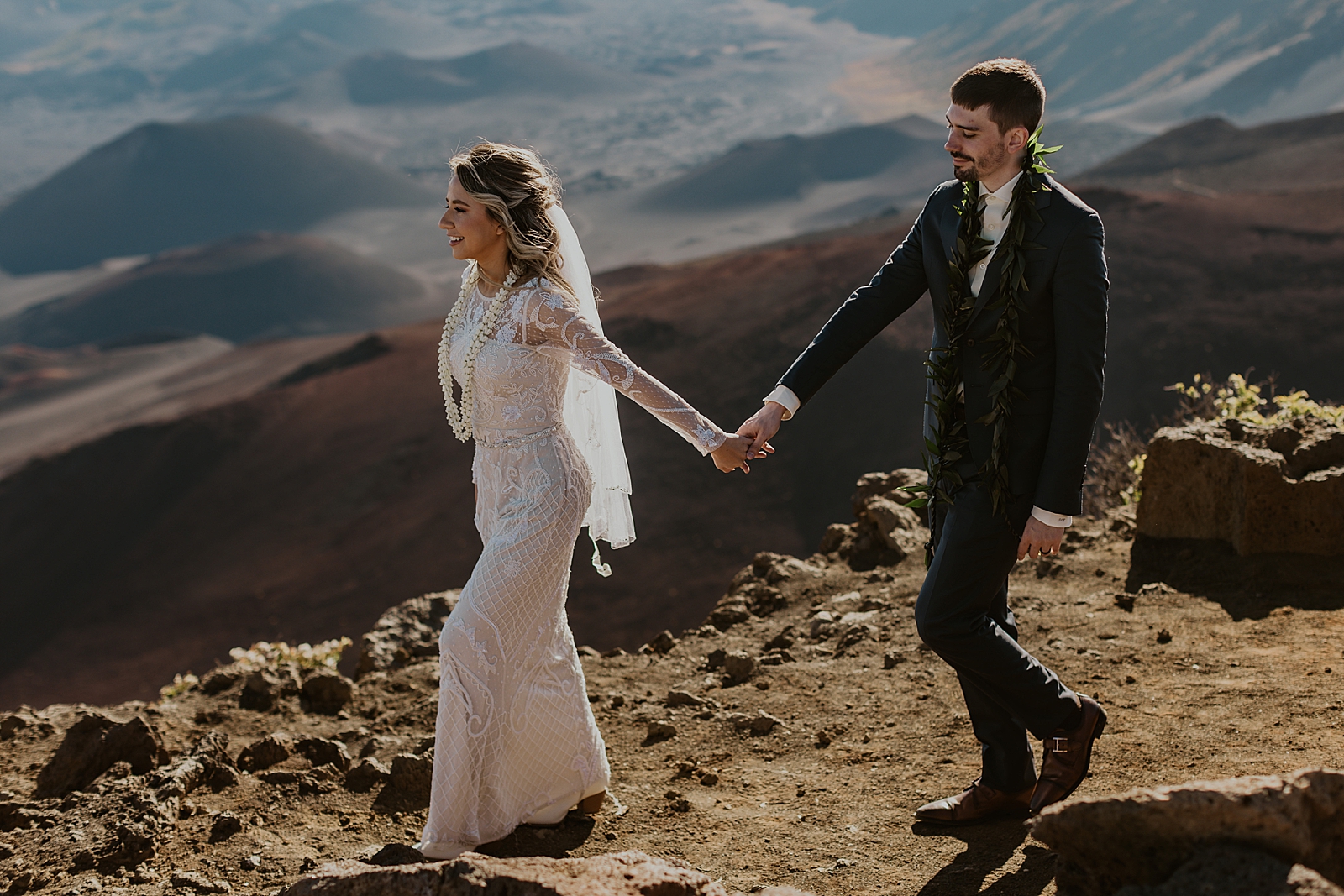 Bride and Groom holding hands walking down the mountain