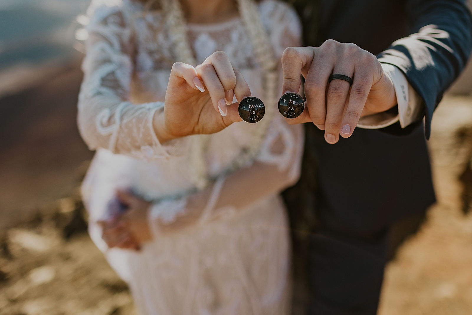 Closeup of Bride and Groom holding wedding pins