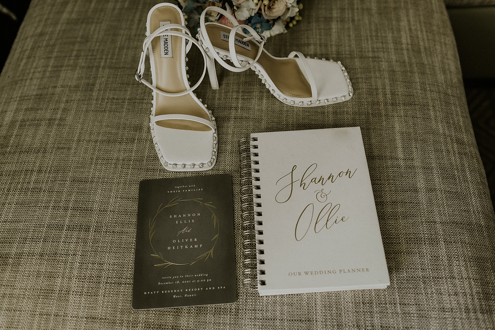 Detail shot of heels with invitations and planning notebook