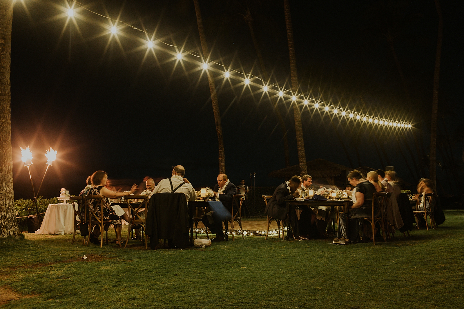 Wide shot of guests at Reception tables for outdoor nighttime Reception