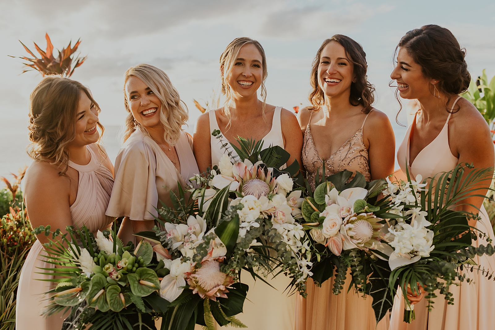 Bride and Bridesmaids with bouquets outside 