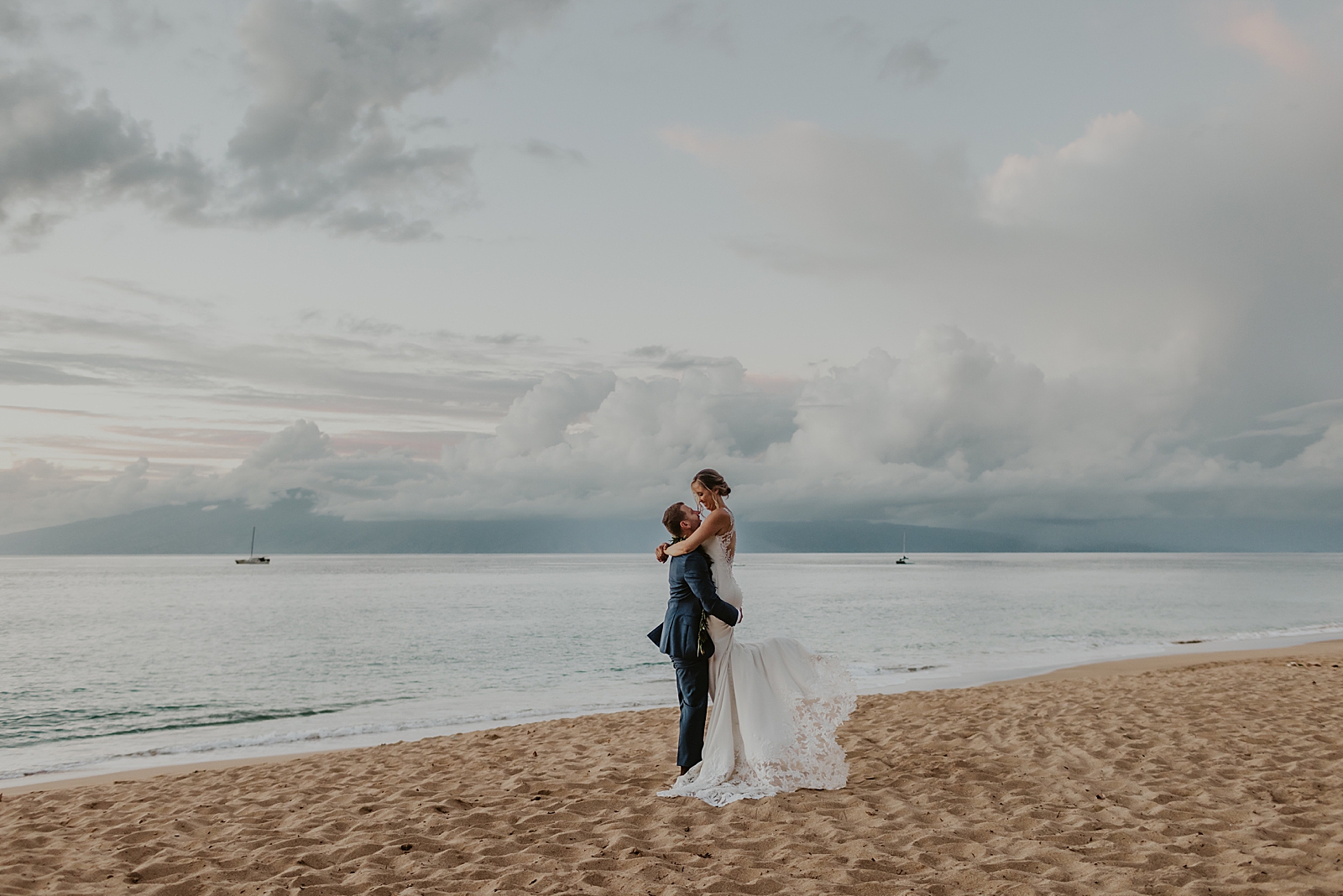 Groom holding Bride up on the beach