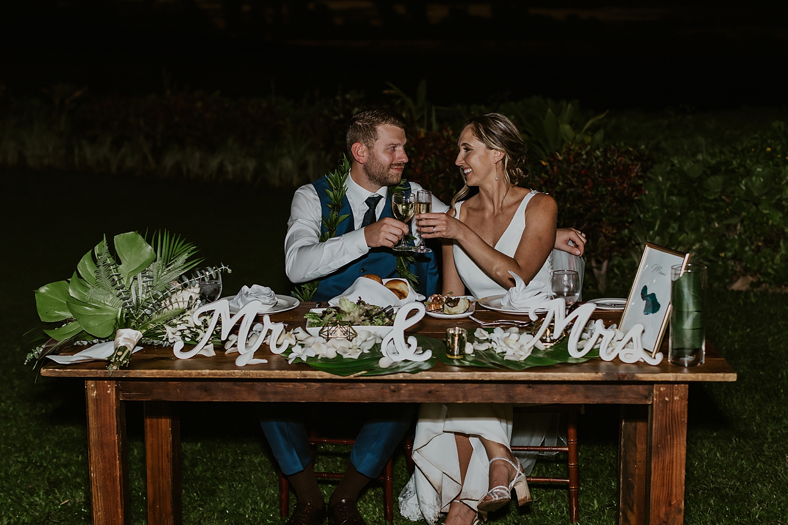 Bride and Groom cheering at sweetheart table