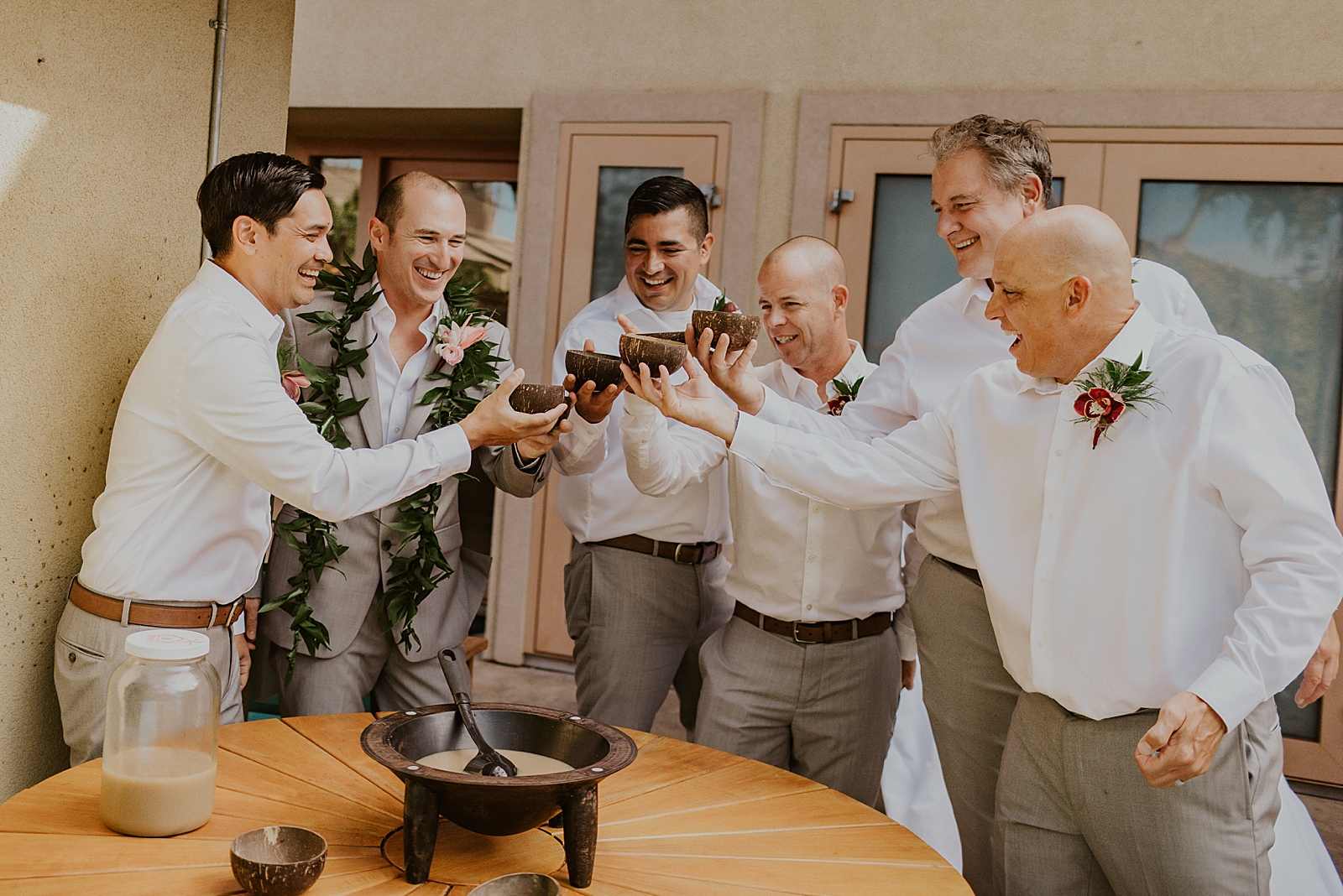 Groom and Groomsmen cheering their drinks while getting ready