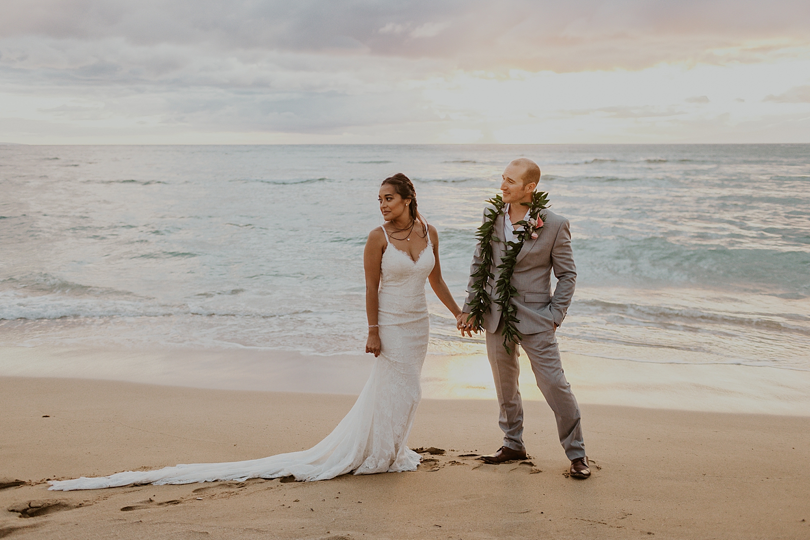 Bride and Groom holding hands in front of the ocean