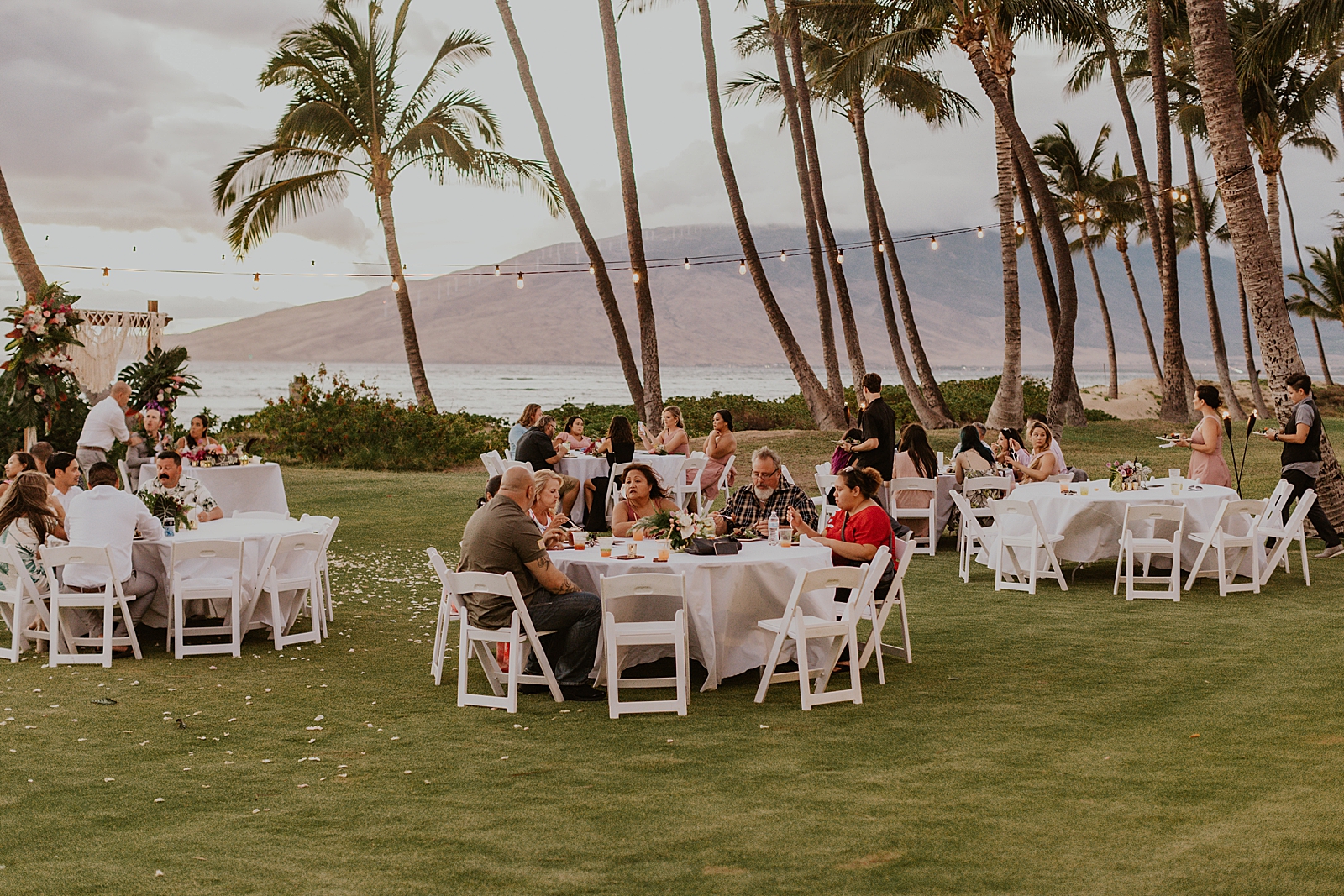 Wide shot of guests socializing at outdoor Reception