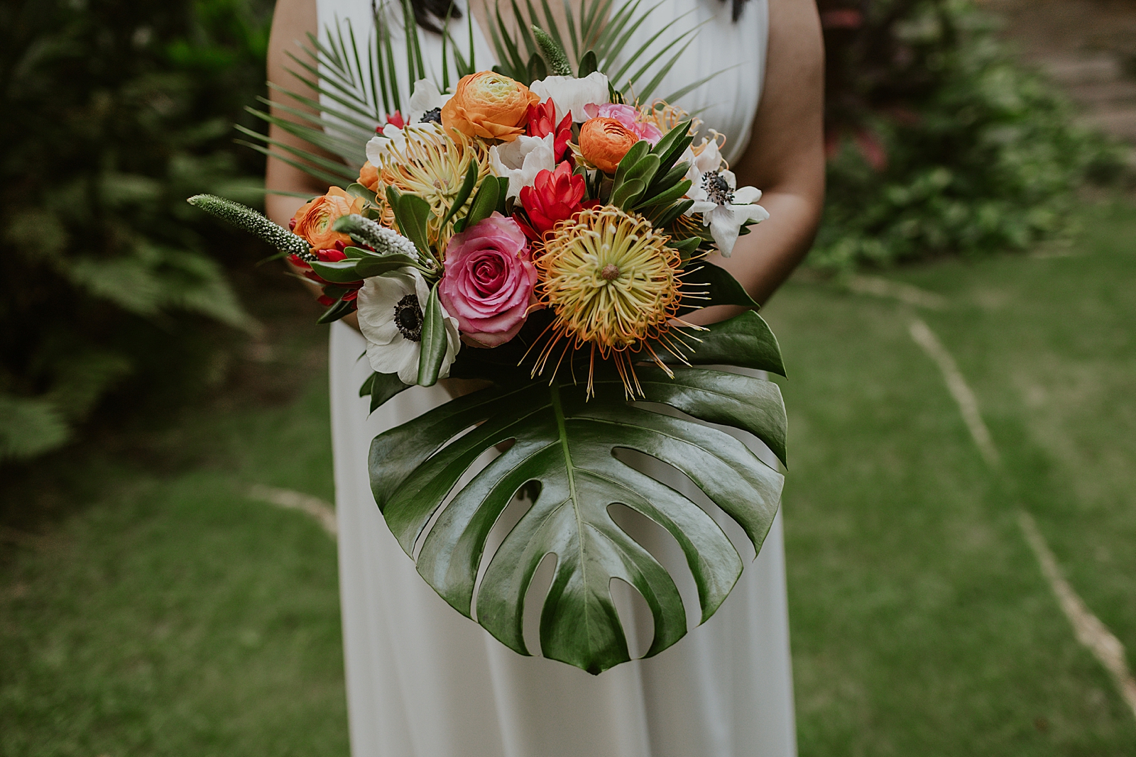 Closeup of Bride with tropical floral bouquet