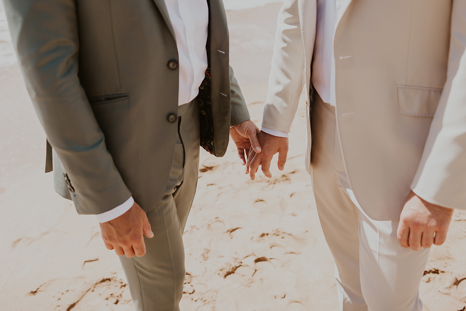 Closeup downward shot of Grooms holding hand