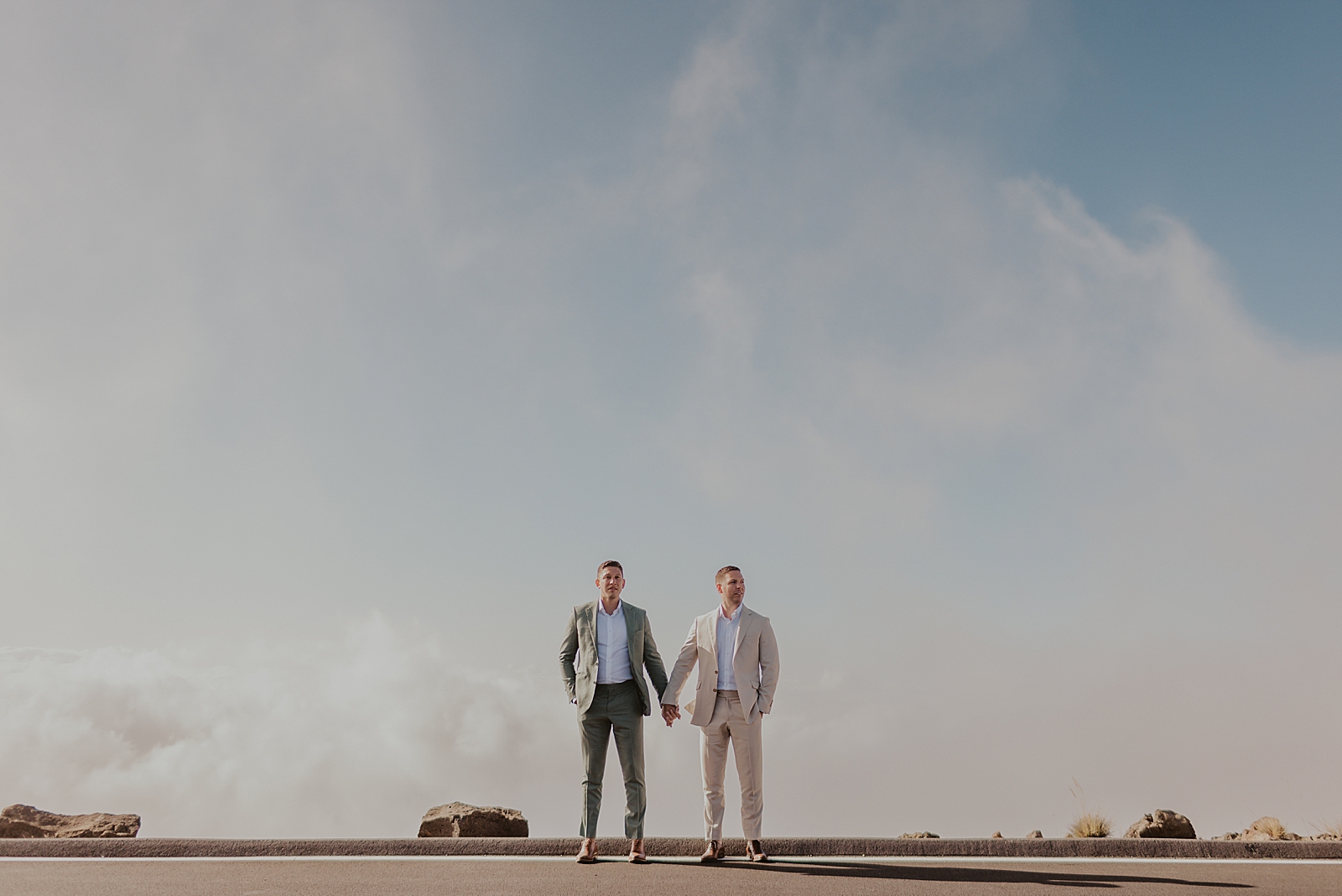 Wide shot of Grooms holding hand with the open sky