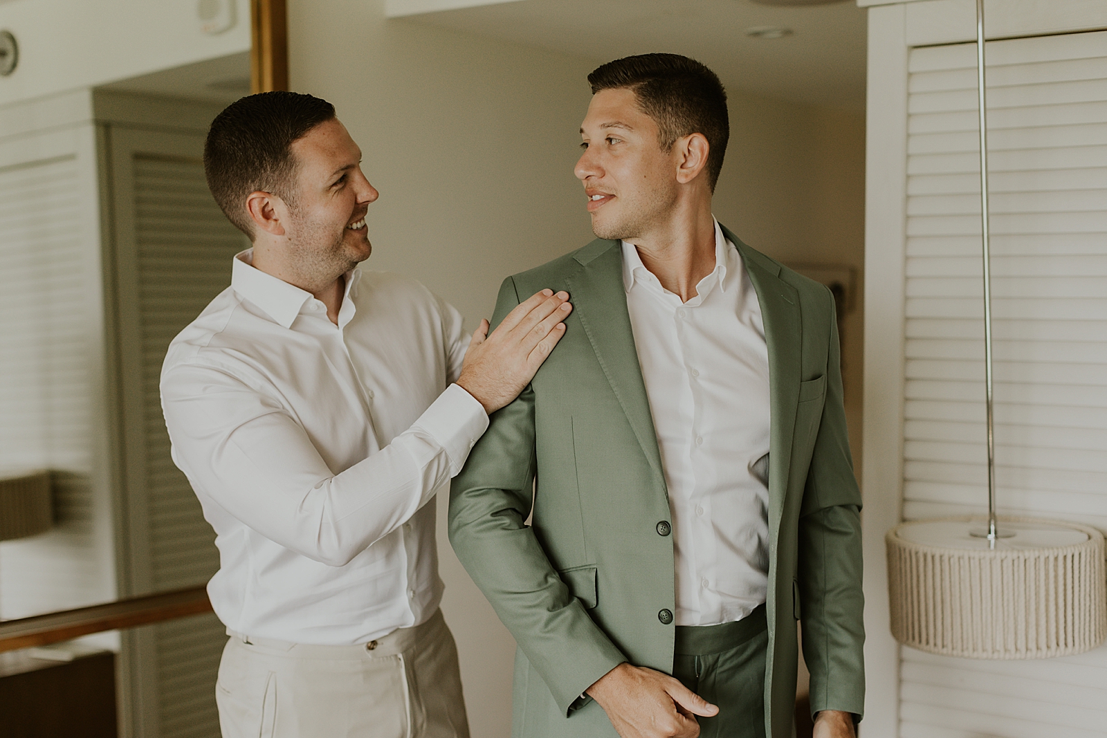 Groom with green jacket on Getting ready